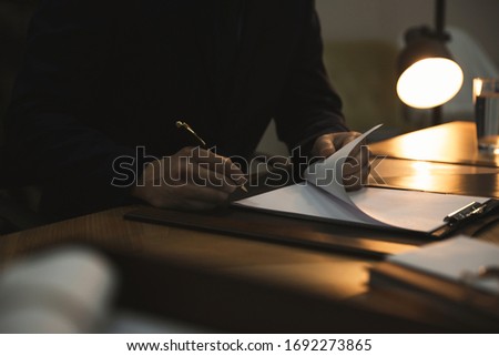 Male lawyer working at table in office, closeup