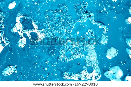 Light blue watercolor ink in water with oil. Futuristic trend background. Planets, the universe and space. Cool trending screensaver. Abstract background.