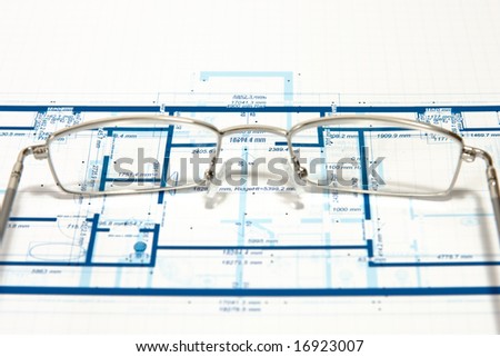 Blueprint for a house and eyeglasses