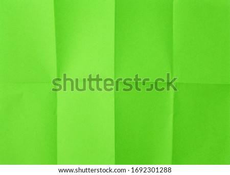 empty green sheet of paper with creases full frame, close up