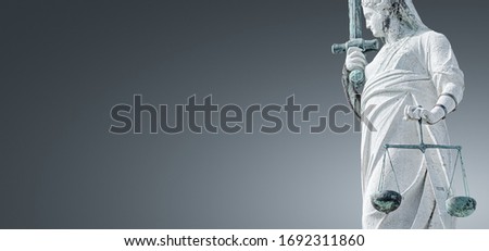 Banner with ancient roof statue of goddess Justice with sword and scale isolated as a decoration at the top of Doge's Palace in Venice, Italy, summer time, gradient background