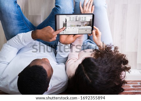 Couple Looking For New Kitchen In Their New Home Royalty-Free Stock Photo #1692355894