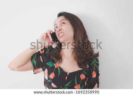 girl is talking on the phone with the customer with anger