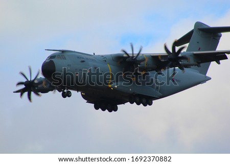 Airbus A400 Atlas military transport plane flying low with wheels down Royalty-Free Stock Photo #1692370882