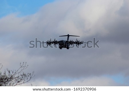 Airbus A400 Atlas Military transport plane flying low towards the camera Royalty-Free Stock Photo #1692370906