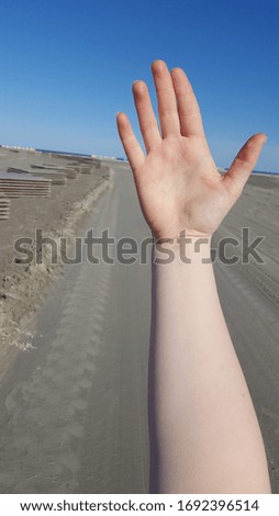 white woman hand on beach background