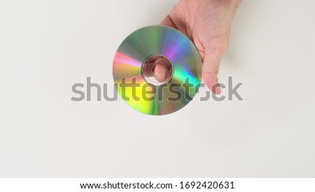 Hand hold disk on white background. Close up.
