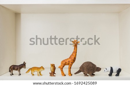 children's toys animals stand on a shelf a giraffe, panda, donke,figure collecting, hobbies