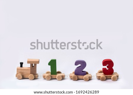 children's toy steam locomotive made of wood stands on the table, isolate, close up