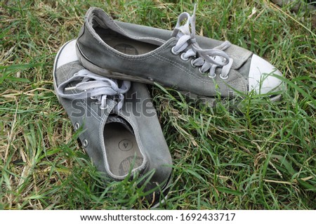Used shoes with a background of green grass texture