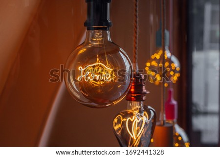 HOME lowing word inside of an electric glass bulb. Decorative concept.