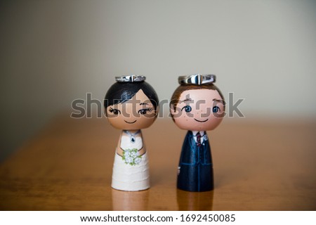 Asian Bride and groom funny miniature. funny Bride and groom cake topper Asian bride close up with wedding rings. 
funny Bride and groom figurines with wedding rings. 