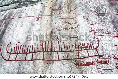 Bronze age rock carving - detail of red vikings ship carved on stone in Tanum, Sweden