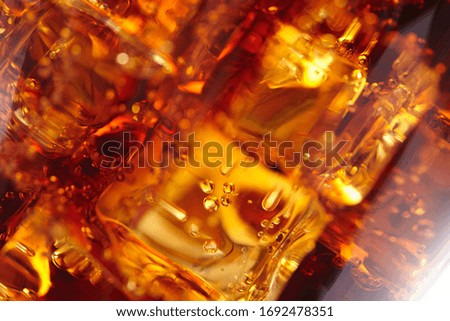 cola with ice cubes macro