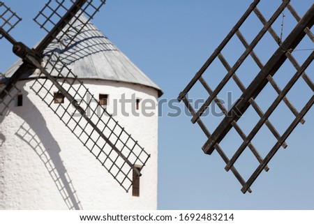 Artistic composition with windmill blade and mill out of focus.