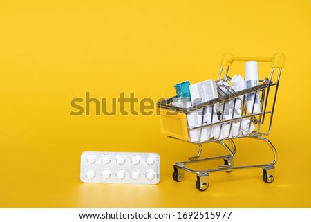 Full grocery cart on yellow background: place for text, banner, delivery of necessary medicinesduring and produts quarantine, epidemics, diseases, assistance. Delivery, online shop