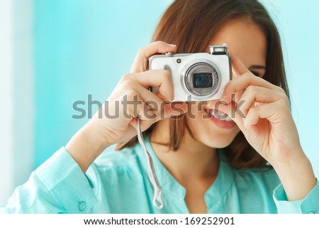 Close up portrait of a beautiful cute teen girl with digital photo camera 