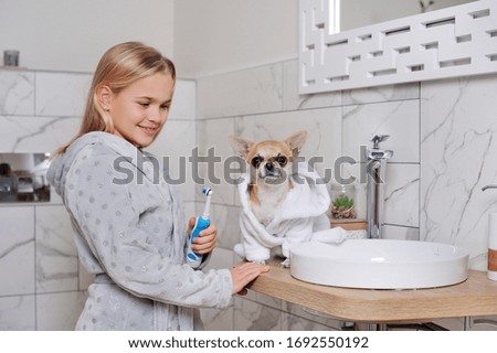 Girl with her dog while morning bathing procedures