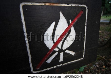 Wooden no open fire sign in a park