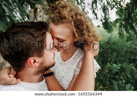 while hugs a guy stroking a girl’s hair