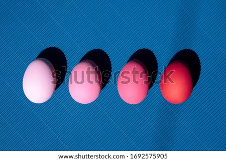Painted eggs on pastel background. Creative minimal concept.