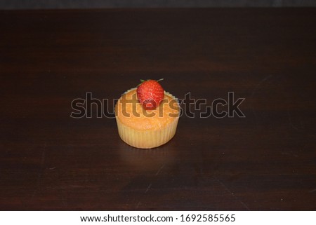 Strawberry cupcake with strawberry on the top, space to add text