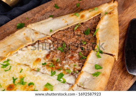 Pide mix with meat mince, onions, parsley, tomatoes, Bulgarian pepper, with cheese baked in the oven
