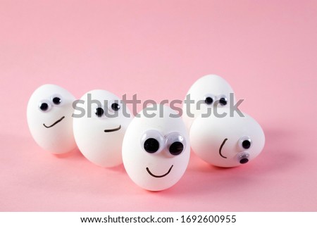 concept social networks communication and emotions - eggs wink on pink background. Copy space