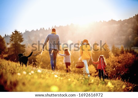 Happy Young family on a background of a summer landscape.