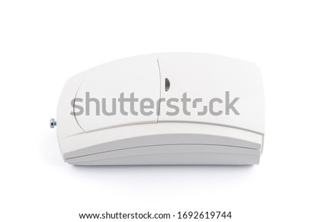 Close-up of motion detector, infrared detector with pet-immunity detection, isolated on a white background. Security alarm systems.