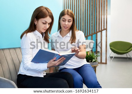 two girls students study at home, girls read a book, science concept, library