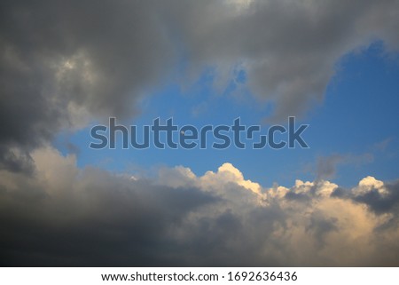 the moon in the light of the setting sun, the sky in a frame of clouds. picture of the evening sky