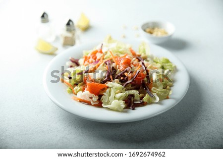 Healthy salad with salmon and pine nuts
