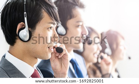 portrait of business person wearing headset working Royalty-Free Stock Photo #1692825001