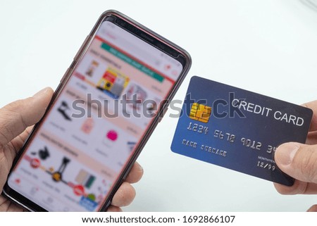 The photo of mobile phone open shopping app and credit card for shopping online concept