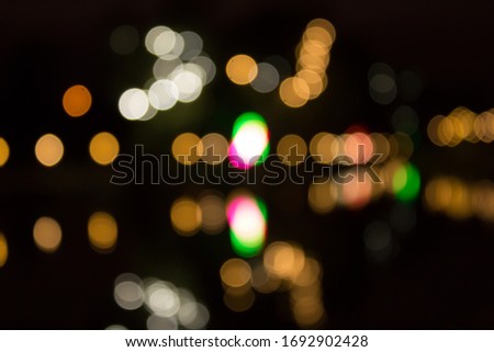 Blur the bokeh of the bulb With beautiful colors at a party at night./Abstract blur light in the night background,
