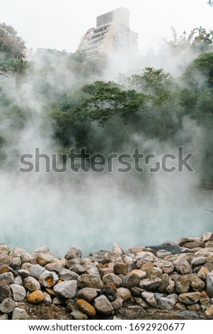 The famous Beitou Thermal Valley in Beitou Park, boiling steam from hot spring floating through the trees in Taipei City, Taiwan.