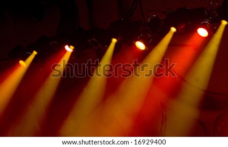 Yellow and orange foggy show lights during rock concert