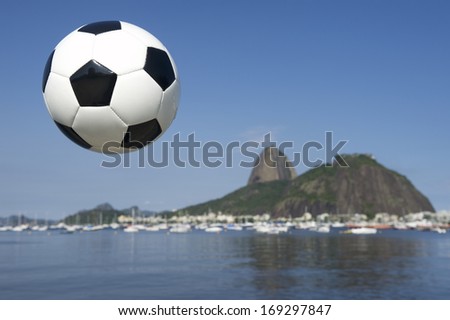 Football soccer ball above Botafogo Bay Rio de Janeiro with Sugarloaf Pao de Acucar Mountain in the background Brazil
