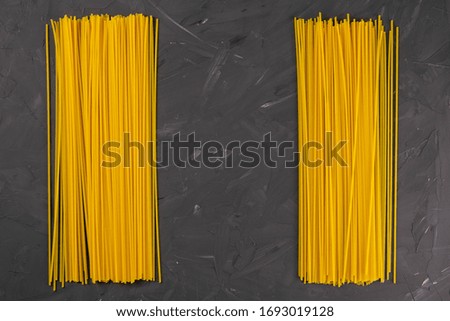 Yellow long spaghetti on a dark background. Top views with clear space