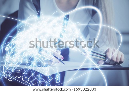 International business hologram over hands taking notes background. Concept of success. Multi exposure