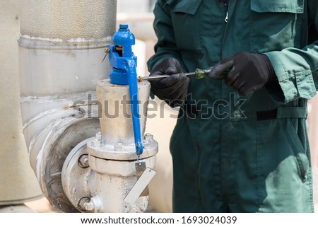 The technician sets up a Pressure Relief Valve test in the maintenance plan. Royalty-Free Stock Photo #1693024039