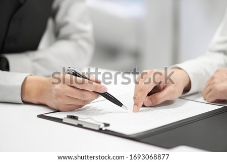 A Japanese male businessman checks the contents of a contract
