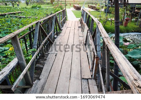 Vintage wooden foot bridge in garden.