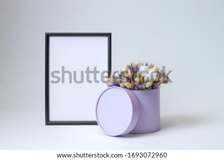 photo frame and decorative arrangement of dried flowers on a white background with copy space