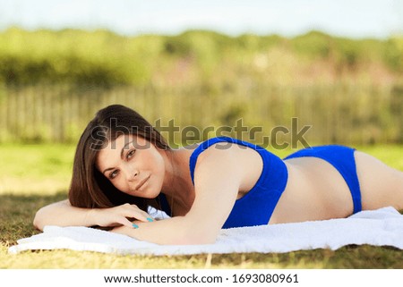 young woman lying in the sun in her bikini