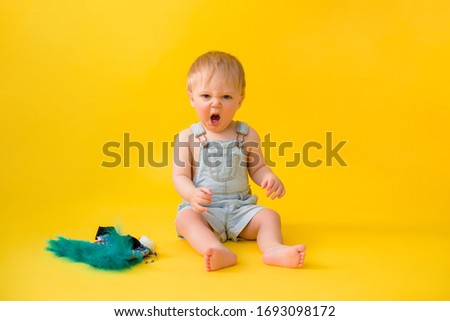 little boy in an Indian costume on a yellow background