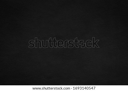 Abstract dark background, Detail of black fabric texture, Canvas textile material pattern, Can be used as backdrop for display or montage your products. Royalty-Free Stock Photo #1693140547