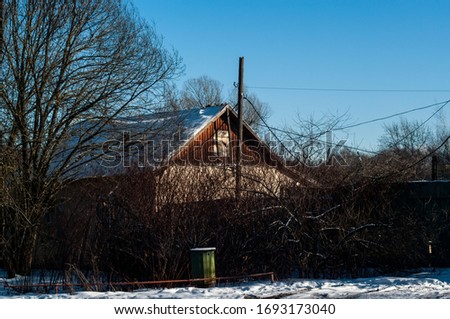rural house behind a fence in winter, Moscow