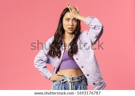Portrait of sick and tired, annoyed young stylish girl taking care of new employee, facepalm, do eye roll and punch forehead sighing bothered, have lots of troubles, stand pink background Royalty-Free Stock Photo #1693176787